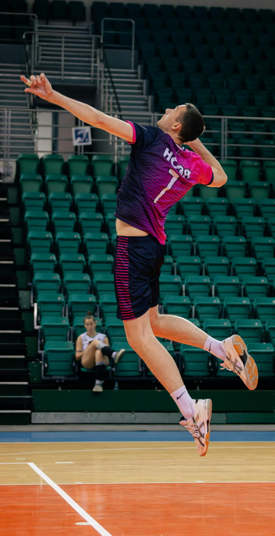 Volleyball player in the air preparing to spike — full-body commitment and athletic decision-making